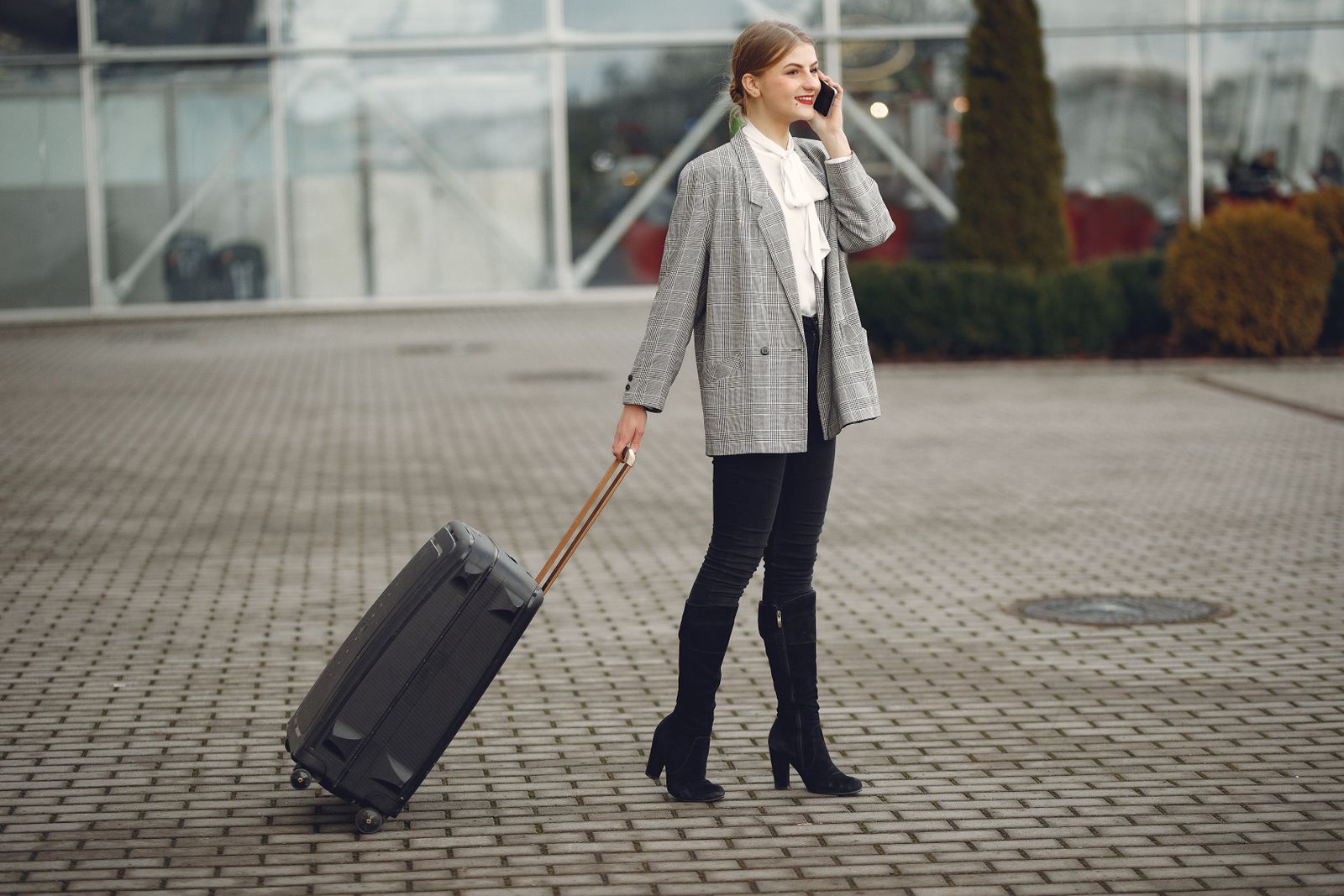 A traveler making an international phone call with luggage nearby